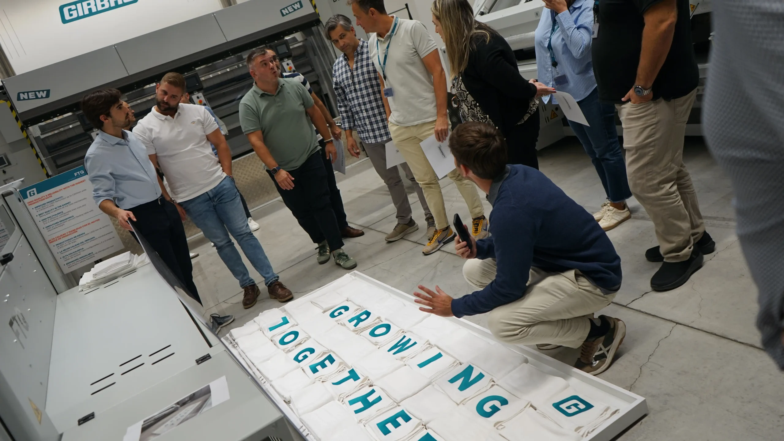 Girbau technical experts reviewing industrial laundry equipment as part of a certified maintenance service to ensure reliable operation.