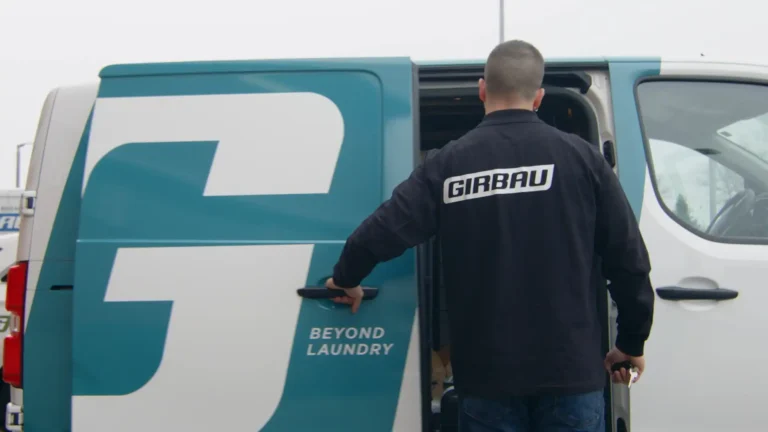 Girbau technician opening service van representing official technical support always available.