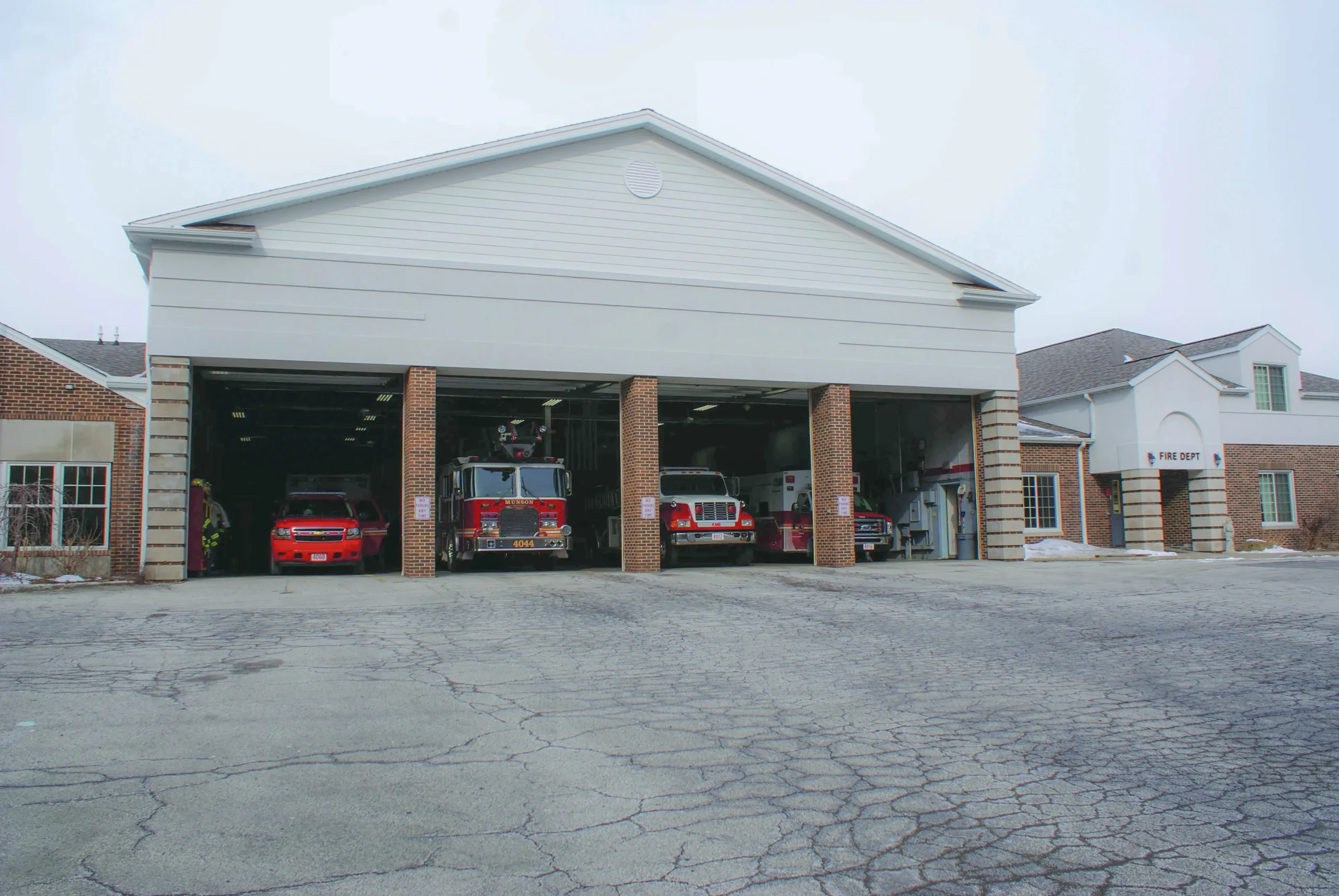 Exterior view of a fire department facility with emergency vehicles, representing institutional and specialized facilities that require internal laundry solutions.