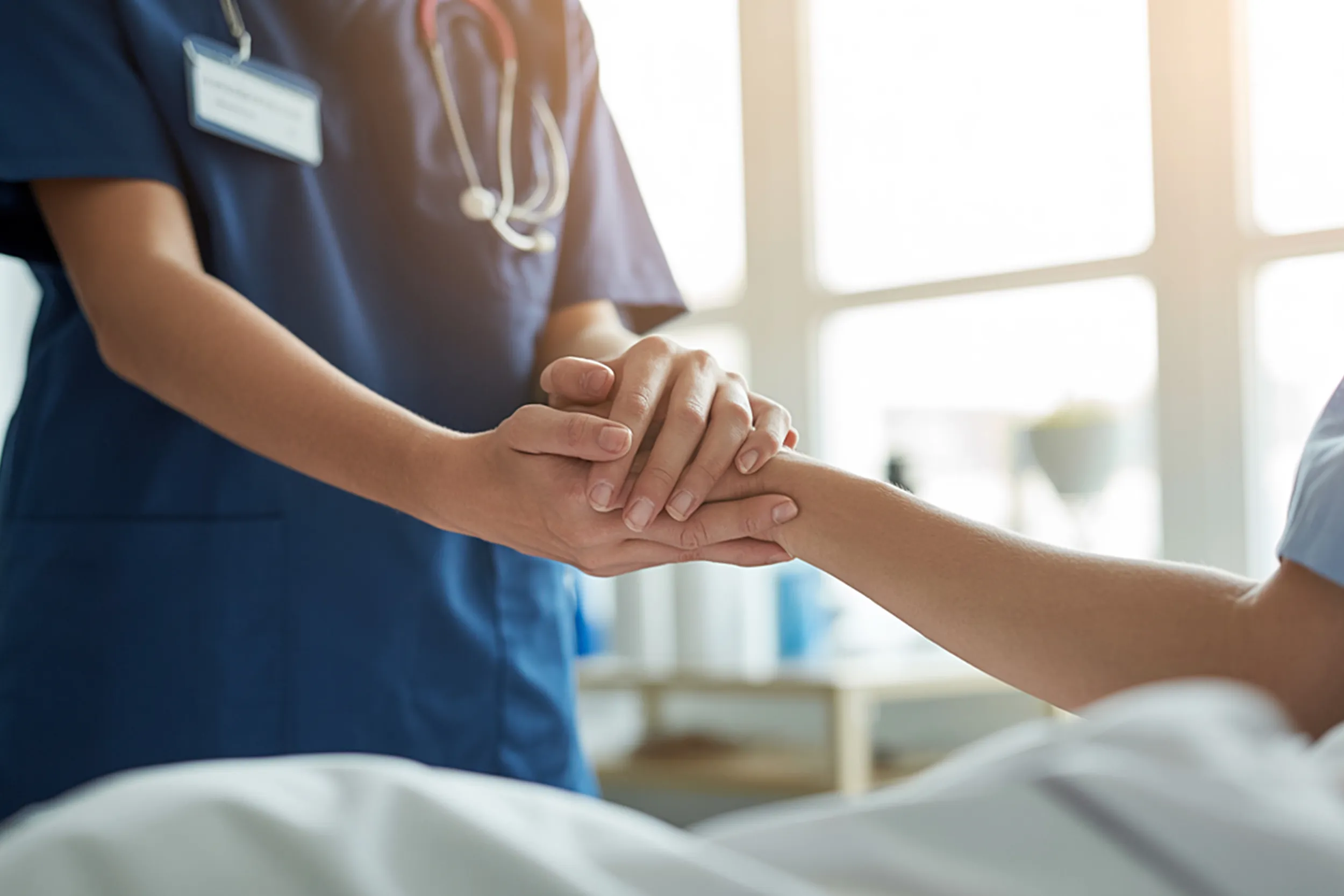 Nurse holding hands with patient