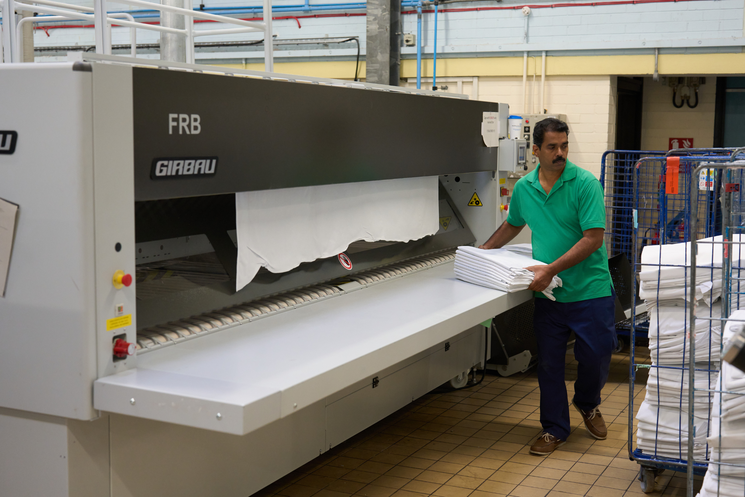 Staff working in industrial laundry for NHS