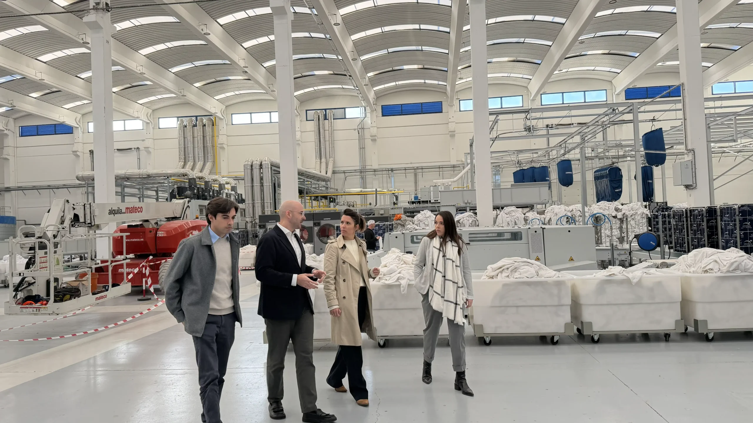 Girbau consultants providing on-site expert support in an industrial laundry to improve operations and long-term efficiency.
