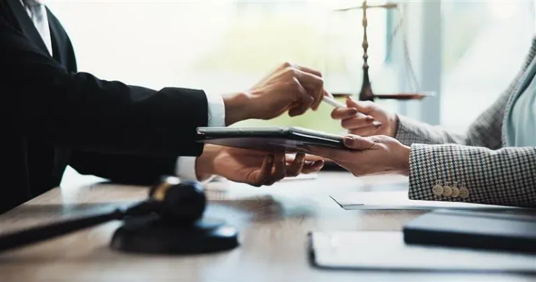 Hands exchanging documents in an office setting symbolizing Girbau’s confidential and secure whistleblowing channel for ethical compliance reporting.