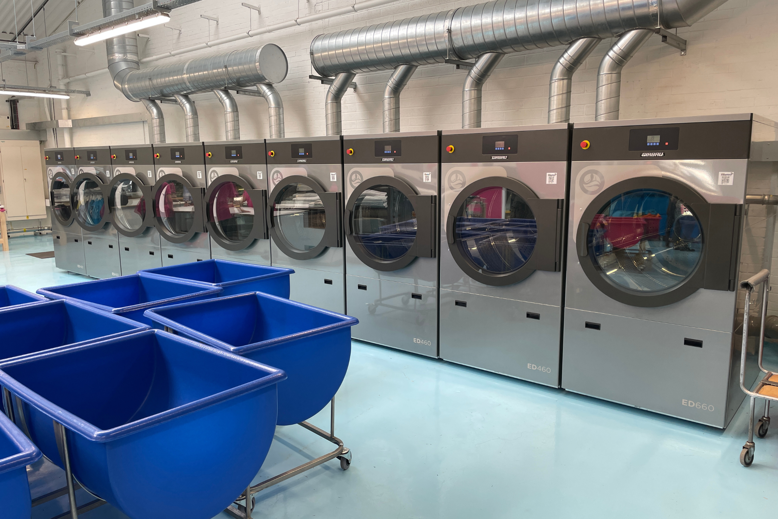 Washing machines and dryers in laundry room at private boarding school