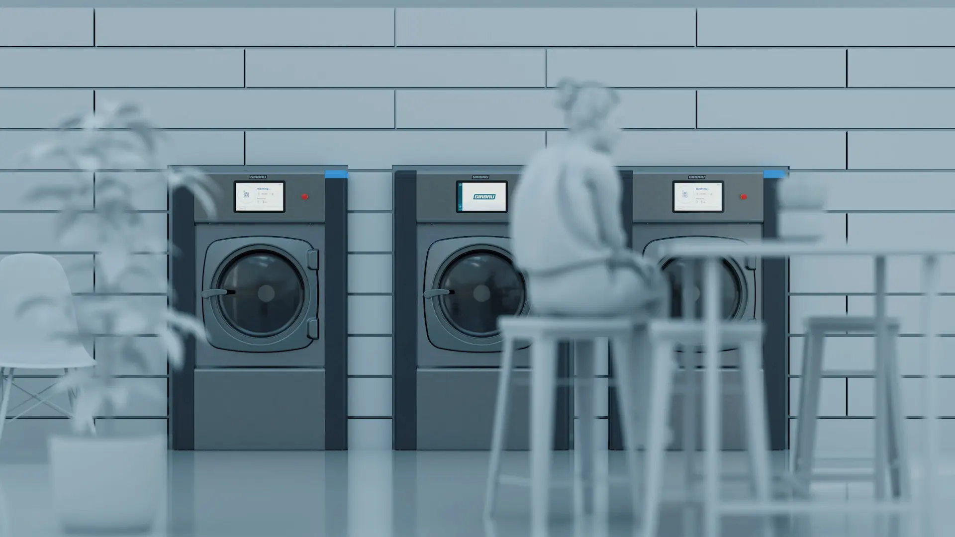 Diseño premiado de las lavadoras comerciales Girbau Genius en un espacio moderno de lavandería autoservicio, mostrando soluciones de lavandería sostenible y eficiente.