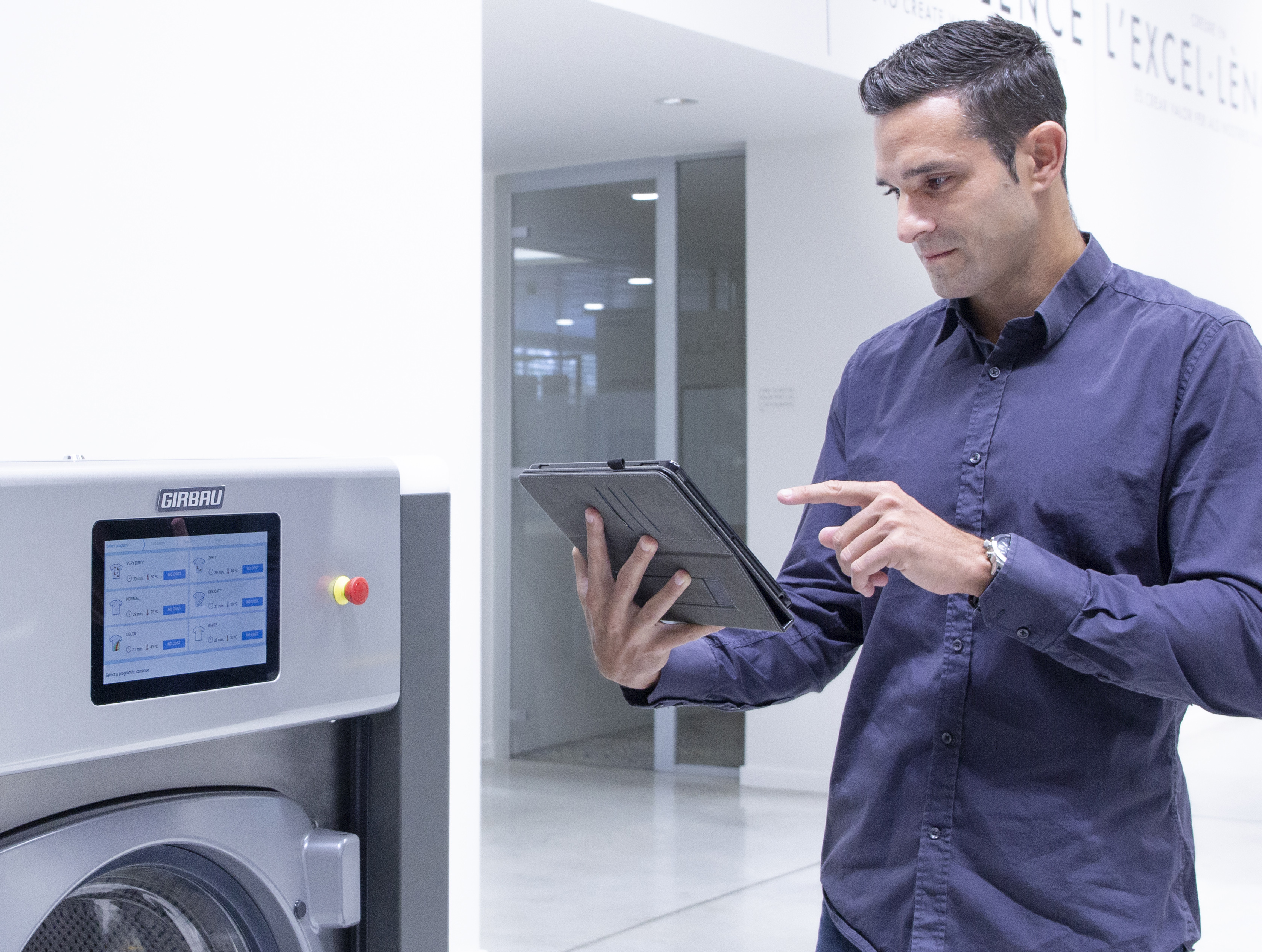 Man remotely controlling a commercial washing machine