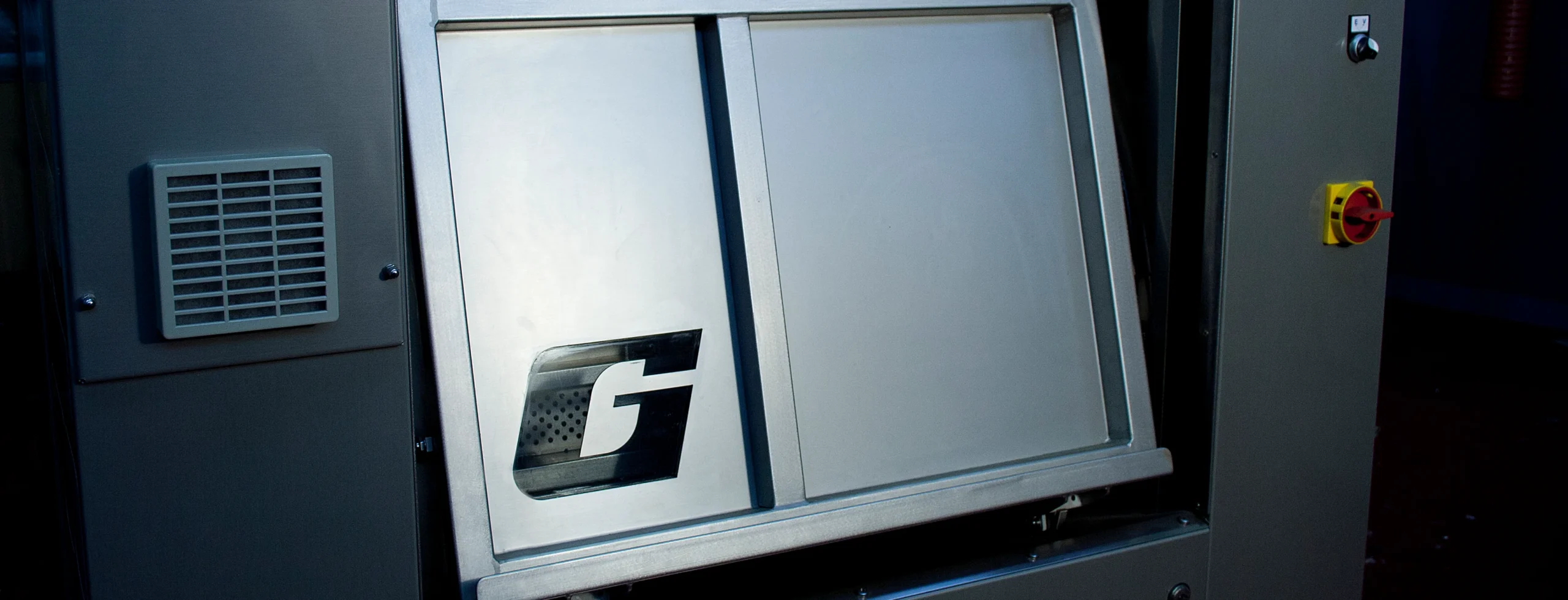 Front view of a hygienic barrier washer with a sealed stainless-steel door, representing contamination-control laundry processes for healthcare and cleanroom environments.