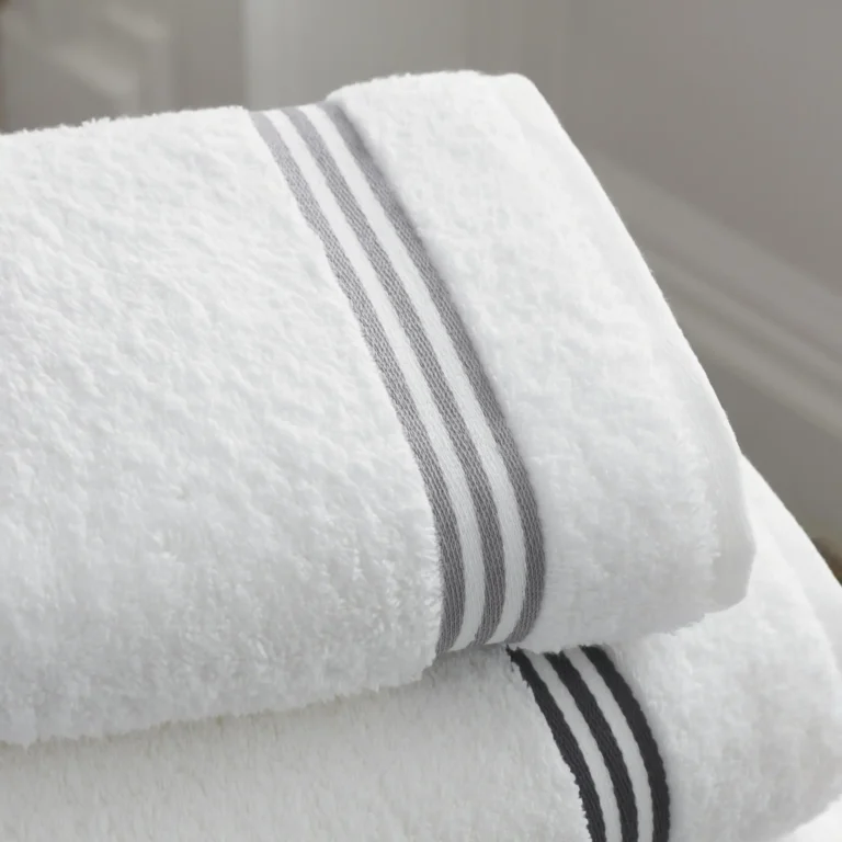 Folded white towels symbolizing Girbau’s decarbonization efforts and its ESG commitment to cleaner production and reduced indirect emissions.