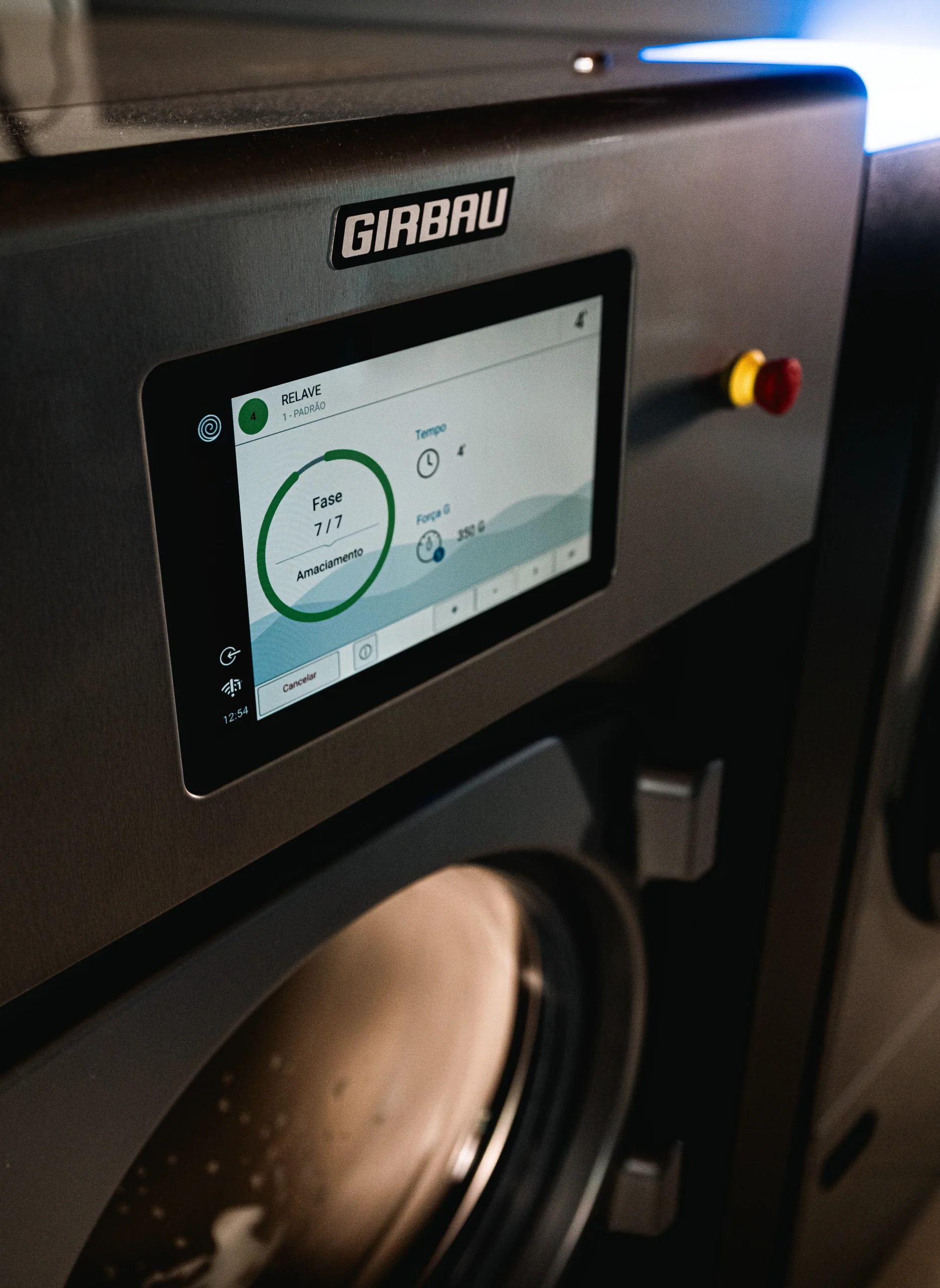 Girbau industrial washer with digital control panel and smart laundry management system.