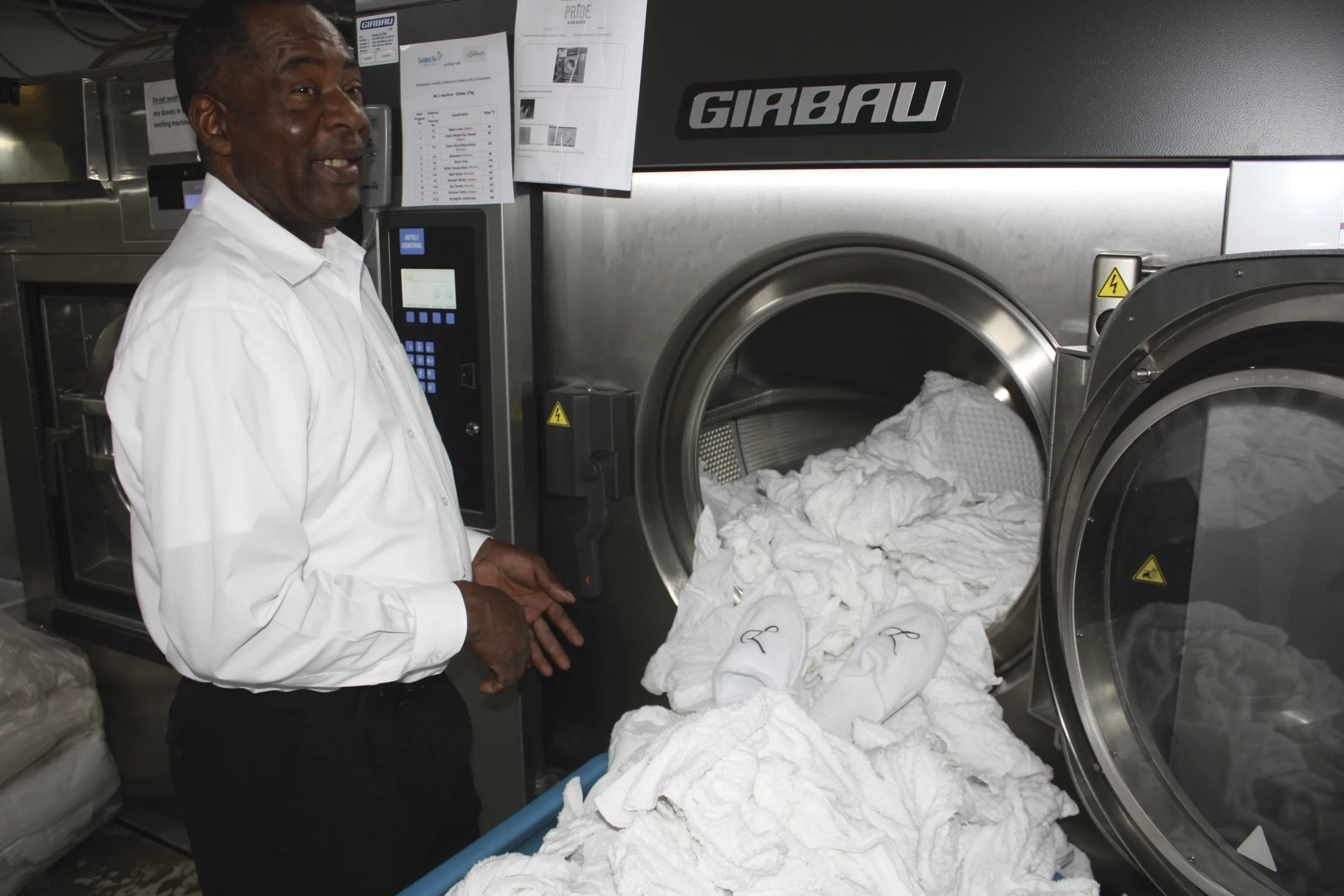 Worker handling white linen