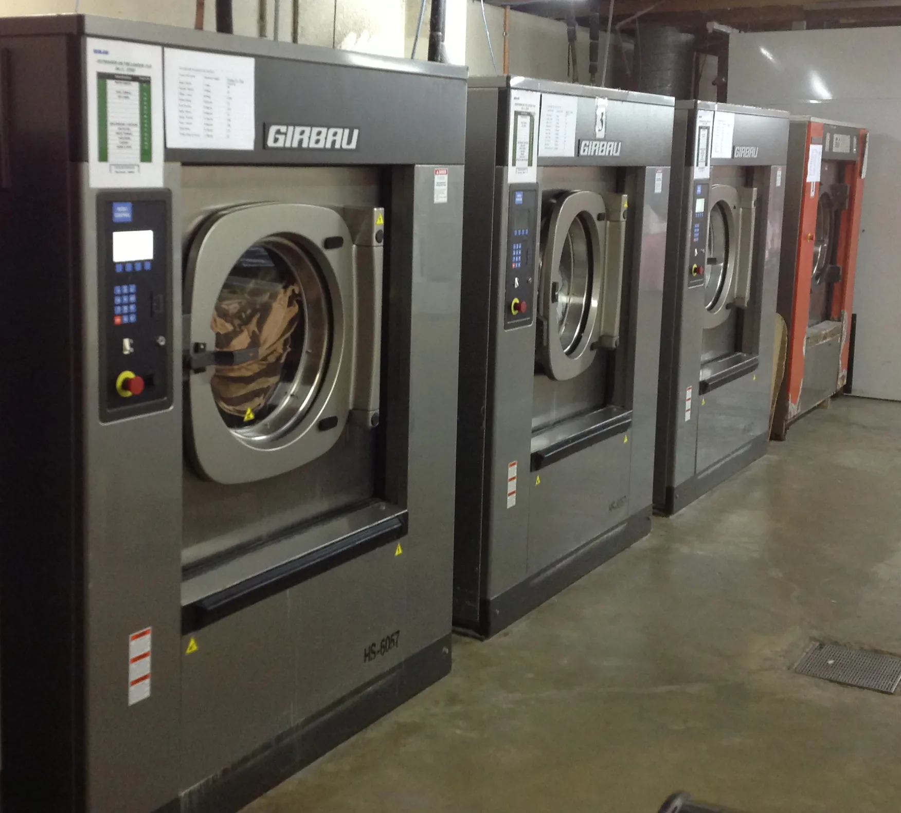 Girbau industrial washers processing large volumes of linen at the Outrigger Fiji resort laundry facility.